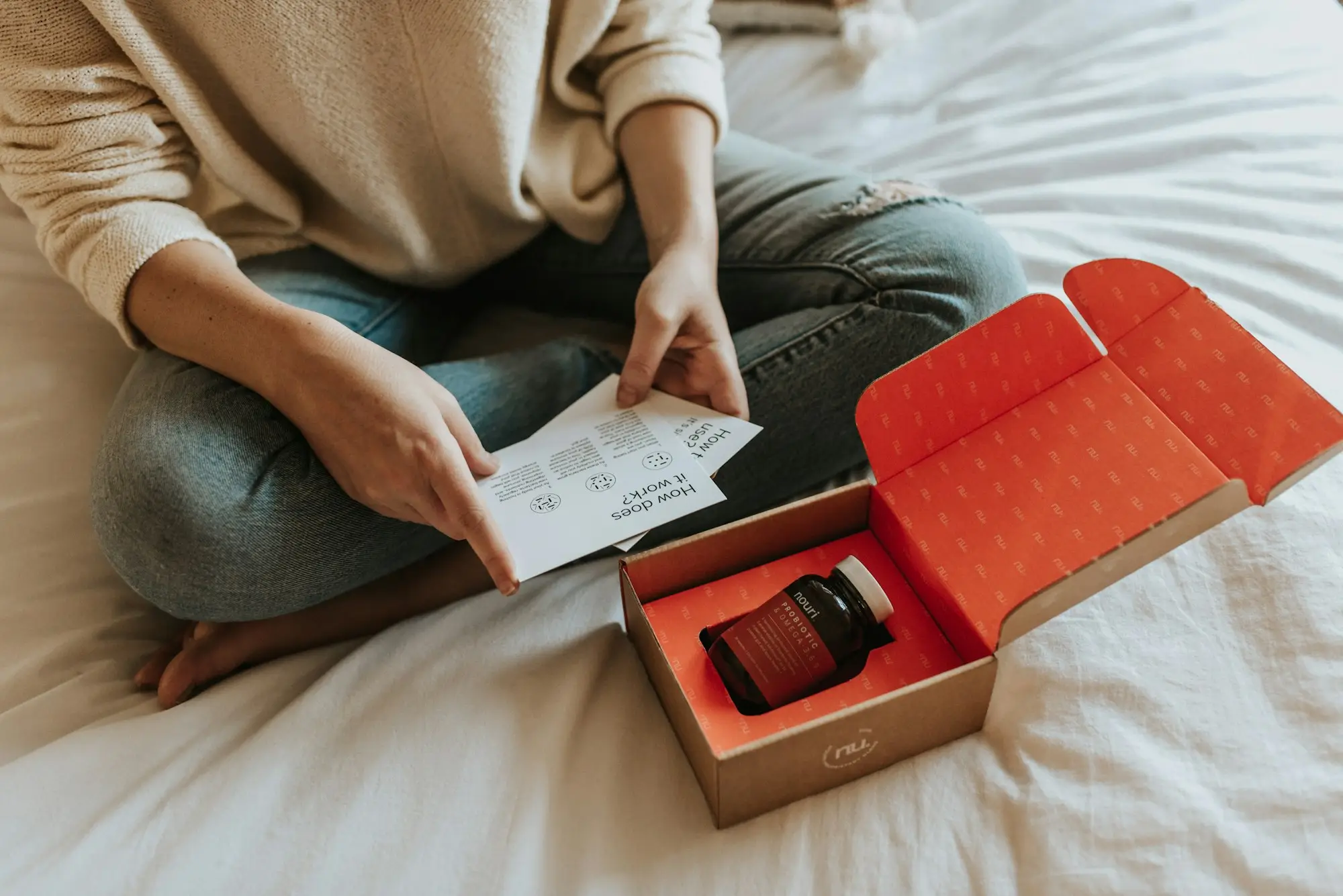 Creator unboxing a gifted product package on the bed
