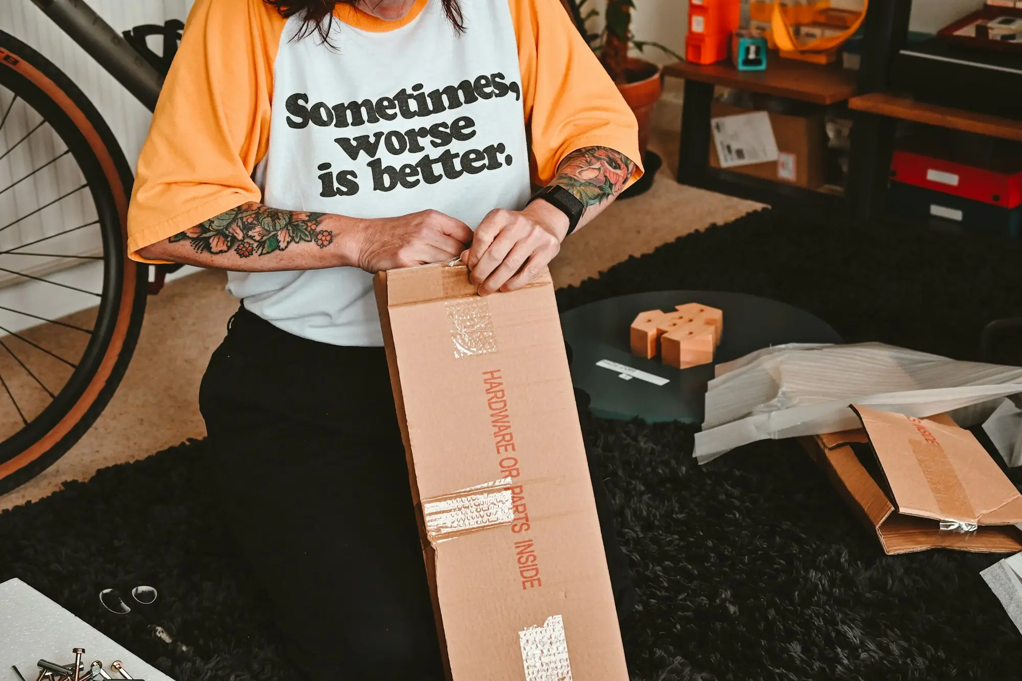Founder taping up a shipping box to pack online orders in a home studio